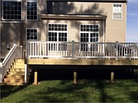 <b>Wood deck and stairs with white vinyl railing</b>